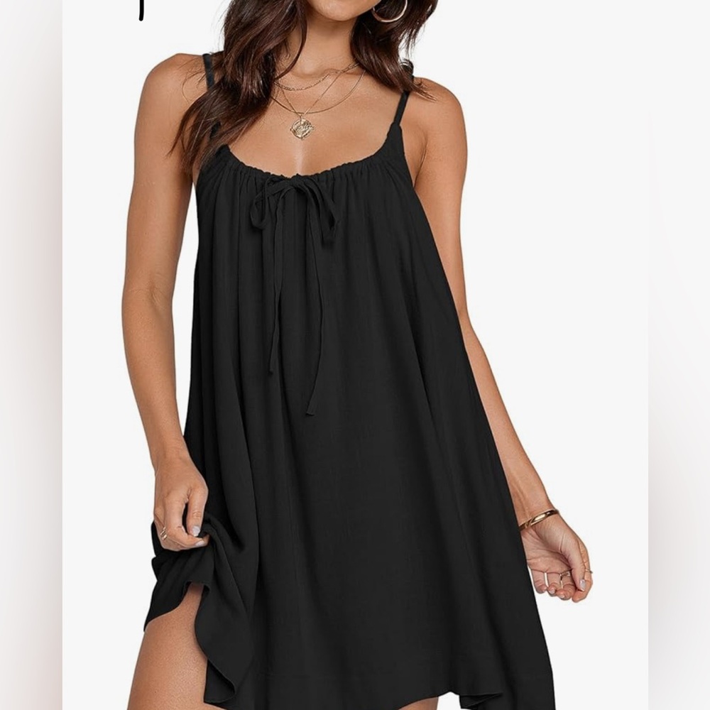Babydoll black dress . Lace on the bottom sheer all over .